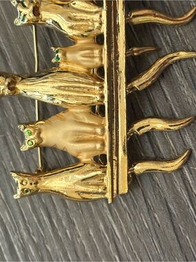 Gold-tone Cat Row Brooch with Green Eyes